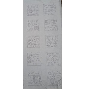 May include: A white fabric panel featuring ten individual square embroidery patterns with line art illustrations and text. Designs include a house, a teapot, a sheep, a bear, and various figures, each accompanied by phrases like Beauty comes in all shapes and sizes, Love makes all things bearable, and Good friends are like quilts.