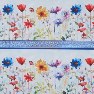 May include: A repeating floral pattern with watercolour flowers in red, orange, blue, and purple. The flowers are set against a pale blue background with a decorative blue border. The design is repeated.