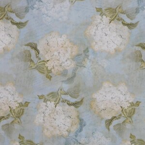 May include: A seamless pattern featuring white hydrangea flowers with green leaves on a light blue background. The flowers and leaves have a watercolour effect, giving the pattern a vintage feel.