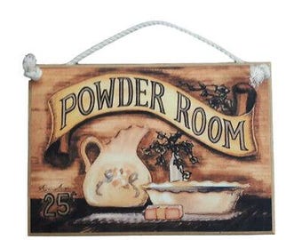 May include: Wooden sign with the words "POWDER ROOM" in a banner. The sign features a vintage illustration of a pitcher, a bowl, and the number "25". A white rope is attached for hanging.