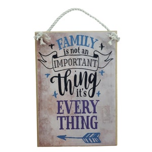 May include: A wooden sign with a distressed background featuring the text "FAMILY is not an IMPORTANT thing it's EVERY THING" with a blue and white arrow at the bottom.