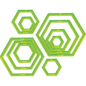 May include: Set of 7 green plastic hexagon-shaped cookie cutters in different sizes. The cutters are labelled with fractions, including 1/2, 1 1/2, 7/8, 3/8, 1 3/4, 1 1/4, 3/4, and 5/8. Each cutter has the text "VT1294" printed on it.