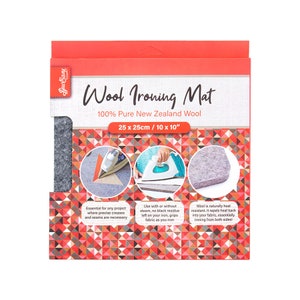 May include: A grey wool ironing mat, 100% New Zealand wool, measuring 10 inches by 10 inches. The mat is packaged in a red and white box with the text "Wool Ironing Mat" and "100% Pure New Zealand Wool".