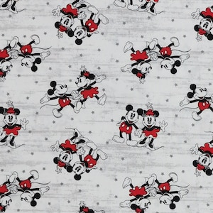 May include: White fabric with a repeating pattern of Mickey Mouse and Minnie Mouse in red, black, and white. The background is a light grey with small white stars.