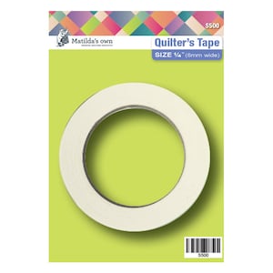 May include: A roll of white quilter's tape, 1/4 inch wide, on a green background. The packaging has the text "Matilda's own" and "Quilter's Tape" with the size and a barcode.