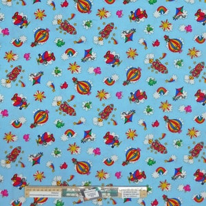 May include: A blue fabric with a repeating pattern of hot air balloons, airplanes, rockets, rainbows, clouds, and suns. The fabric is perfect for quilting, crafts, and other sewing projects.