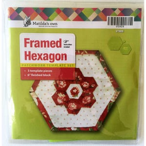 May include: Matilda's Own Framed Hexagon patchwork template set in clear plastic packaging. The label features the text Framed Hexagon, 3 template pieces, and 6" finished block. The graphic shows a floral hexagon quilt block design.