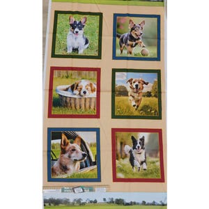 May include: A beige fabric with six squares featuring different dog breeds. Each square has a dark green, red, and blue border. The dogs are a corgi, a border collie, a terrier, a golden retriever, a black and white dog, and a brown and white dog.