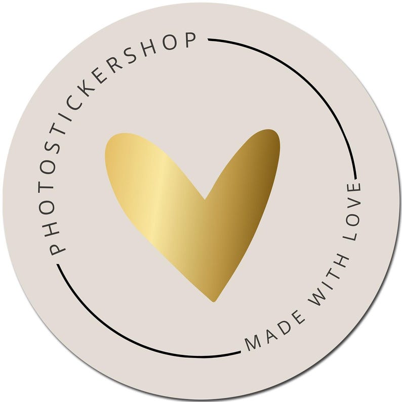 May include: A round sticker with a light beige background. A gold heart is in the center. The words "PHOTOTICKERSHOP" and "MADE WITH LOVE" are printed in black around the edge of the sticker.