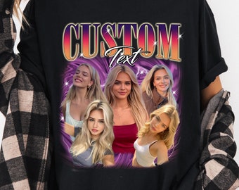 May include: Black t-shirt with a graphic design featuring a purple and pink background with four women's faces and the text "CUSTOM Text" in gold letters.
