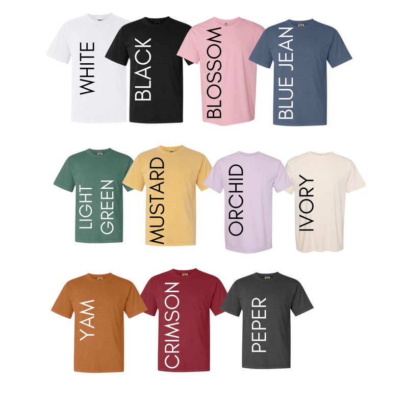 May include: Twelve different color t-shirts with the color name printed vertically on the front of each shirt. The colors are white, black, blossom, blue jean, light green, mustard, orchid, ivory, yam, crimson, pepper.