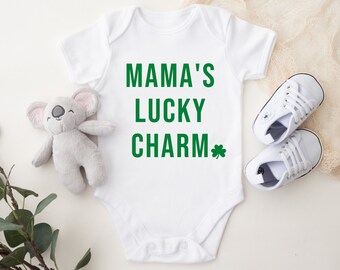 May include: White baby onesie with green text that reads "Mama's Lucky Charm" with a green shamrock.