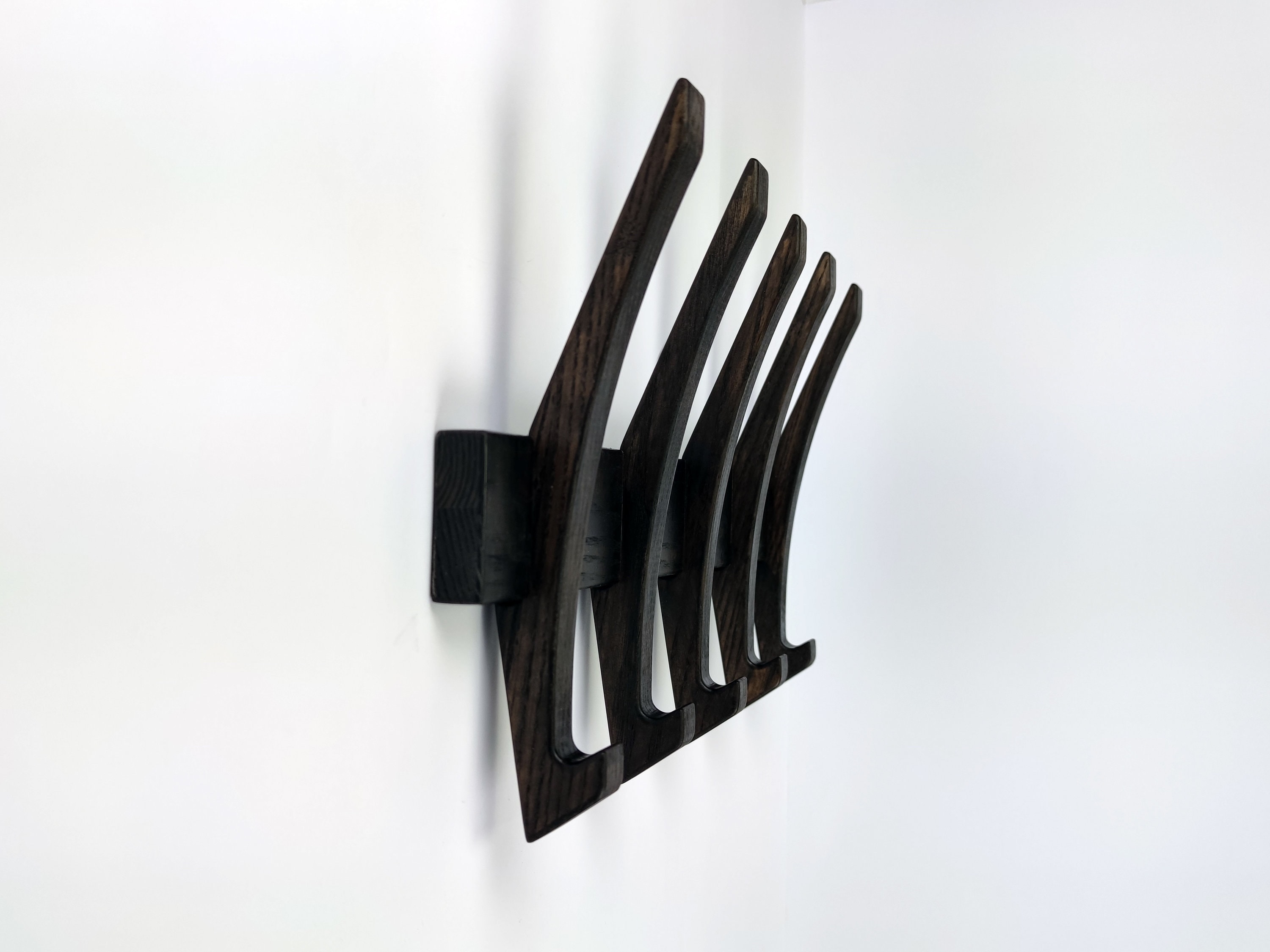 Wall coat hook black color. Coat hanger. Wooden coat rack.