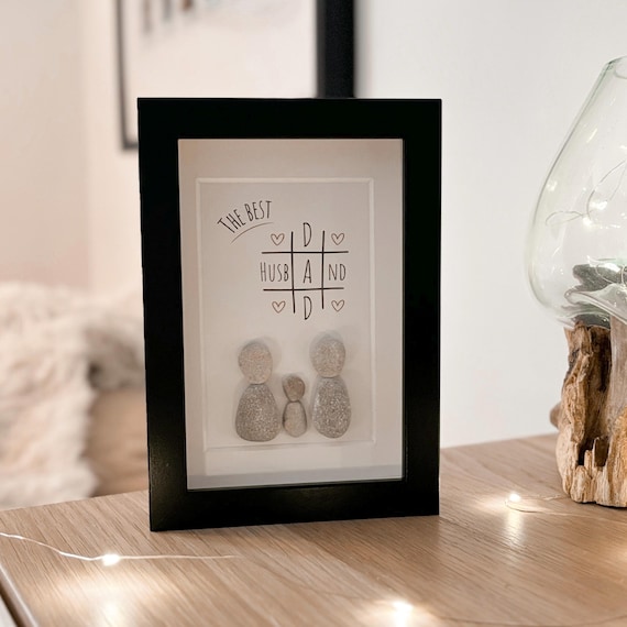 Tiny pebble art portrait custom-made from a child's name or photo — a genuinely handmade miniature keepsake that dads actually want to put on their desk.