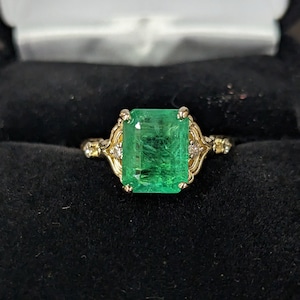 Certified 3.5 Carat Emerald set in 14 Karat Yellow Gold Ring with 4 diamonds
