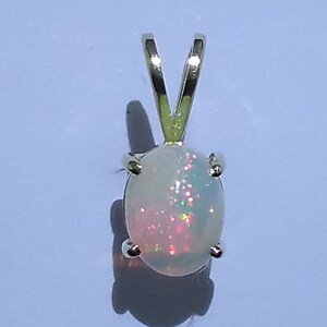 2.0 carat Ethiopian opal set in a 14 karat solid yellow gold rabbit pendant