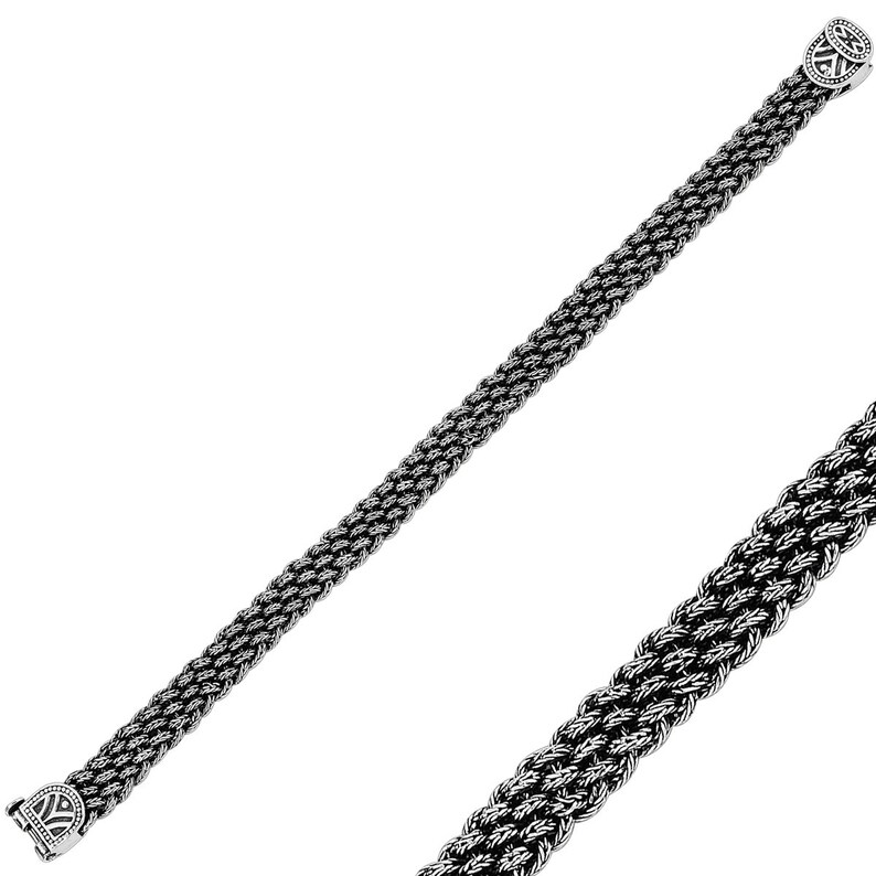 May include: A silver bracelet with a braided chain design and decorative end caps.