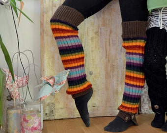 May include: Two pairs of colorful striped leg warmers. One pair is brown, orange, purple, and black. The other pair is black with a brown cuff.