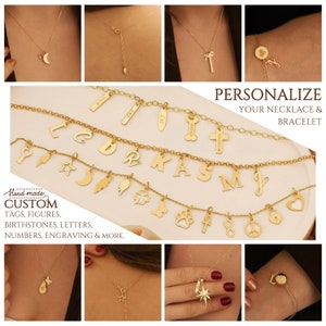 May include: A collection of gold necklaces and bracelets featuring a variety of charms, including letters, symbols, and figures. The charms are customisable and can be personalised with names, dates, or other meaningful details. The text "PERSONALIZE YOUR NECKLACE & BRACELET" is displayed above the jewellery.