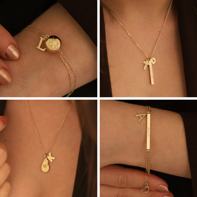May include: Four gold necklaces and bracelets with charms, including a heart, a dog, a letter 'L', a letter 'A', and a letter 'K'. The charms are on a chain or a bracelet with a bar that says 'Forever' and 'Love is'.