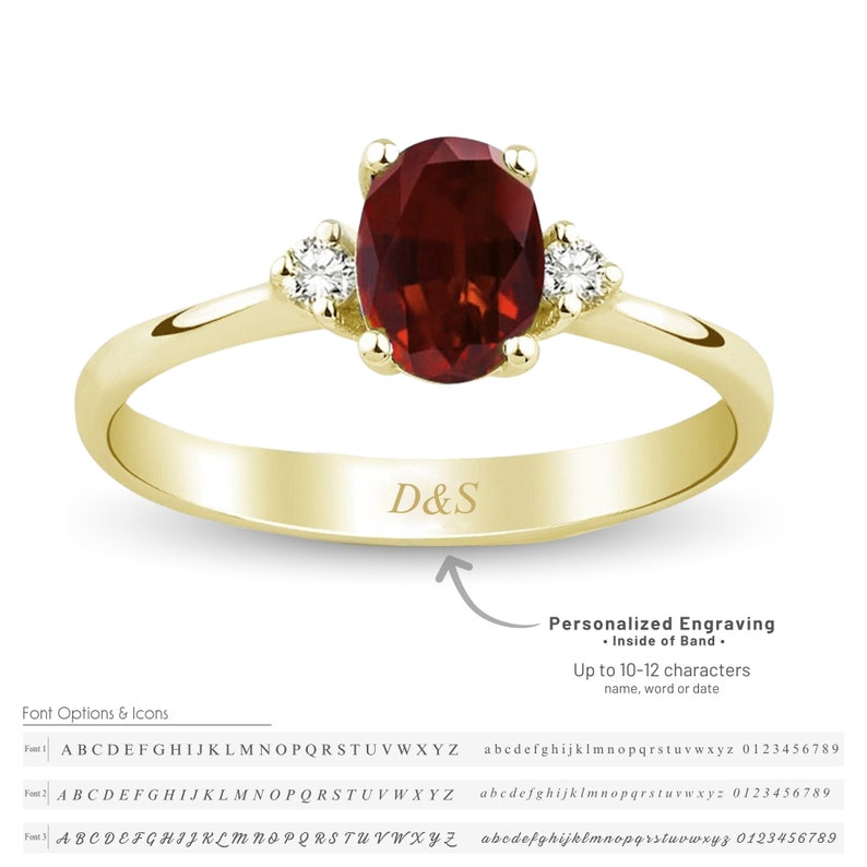 May include: A gold band ring with a red oval gemstone and two smaller white gemstones on either side. The ring has the inscription "D&S" on the inside of the band. The image includes text that reads "Personalized Engraving - Inside of Band - Up to 10-12 characters name, word or date".