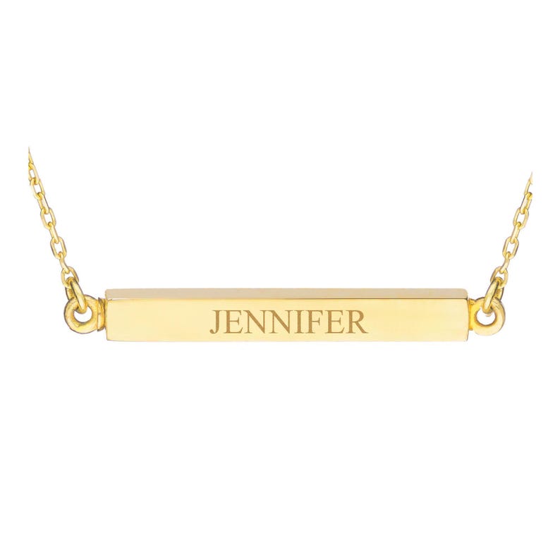 May include: A gold bar necklace with the name "JENNIFER" engraved on it.
