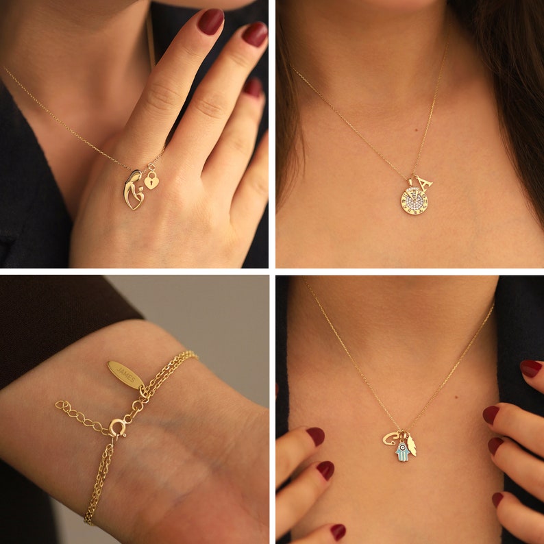 May include: Four gold necklaces with different charms. The first necklace has a mother and child charm with a small heart lock. The second necklace has a round charm with a letter A and small diamonds. The third necklace has a charm with a small hand with an eye and a feather. The fourth necklace has a charm with the word "JAMES" on a small tag.