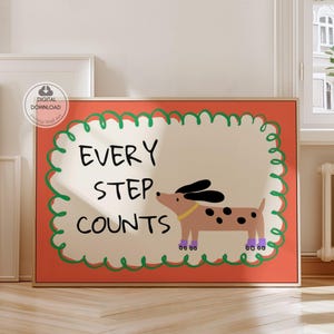 May include: Framed print featuring the text "EVERY STEP COUNTS" and a cartoon dog. The dog is brown with black spots, black ears, and purple shoes. The print has a red background with a green border.