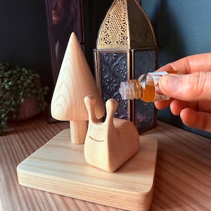 May include: A set of three ceramic mugs with a speckled, matte finish. The mugs are in shades of cream, light grey, and dark grey. Each mug has a simple, minimalist design, ideal for coffee or tea.