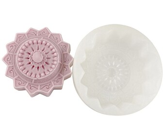 May include: A pink silicone mold for making soap or resin crafts. The mold is shaped like a flower with a detailed mandala design.