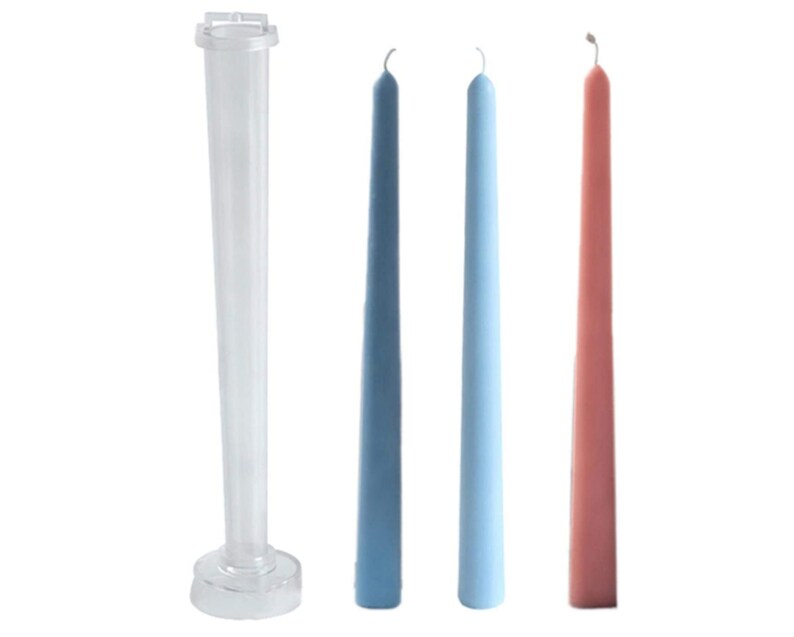 May include: A clear plastic candle mold next to three taper candles. The candles are in shades of blue and a dusty rose color. The candles are long and slender, with a slight curve at the top.