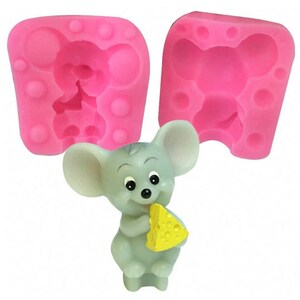 May include: Pink silicone mold for making a small mouse figurine holding a piece of cheese. The mold is in two pieces and has a detailed design.