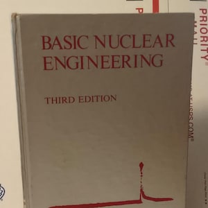 May include: A hardcover book titled "BASIC NUCLEAR ENGINEERING" in red lettering. The book is a third edition, with the authors Arthur R. Foster and Robert L. Wright, Jr. The cover is a light beige color with a red graphic.