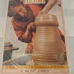 May include: A book titled "The Craft of the Potter" with a man working on a pottery wheel. The cover features a potter in an orange shirt shaping a clay pot. The book's title is in a decorative font, and the text "A Practical Guide to Making Pottery" is also visible.