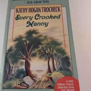 May include: A book cover with a green background and a painting of a forest scene. The title is "Every Crooked Nanny" and the author is "Kathy Hogan Trocheck". The book is a Callahan Garrity Mystery and an Editors' Choice Selection from The Drood Review.