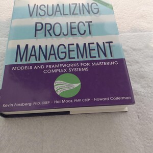 May include: A purple and blue book titled "Visualizing Project Management: Models and Frameworks for Mastering Complex Systems" with the words "Third Edition" on the cover. The book is by Kevin Forsberg, Hal Mooz, and Howard Cotterman.