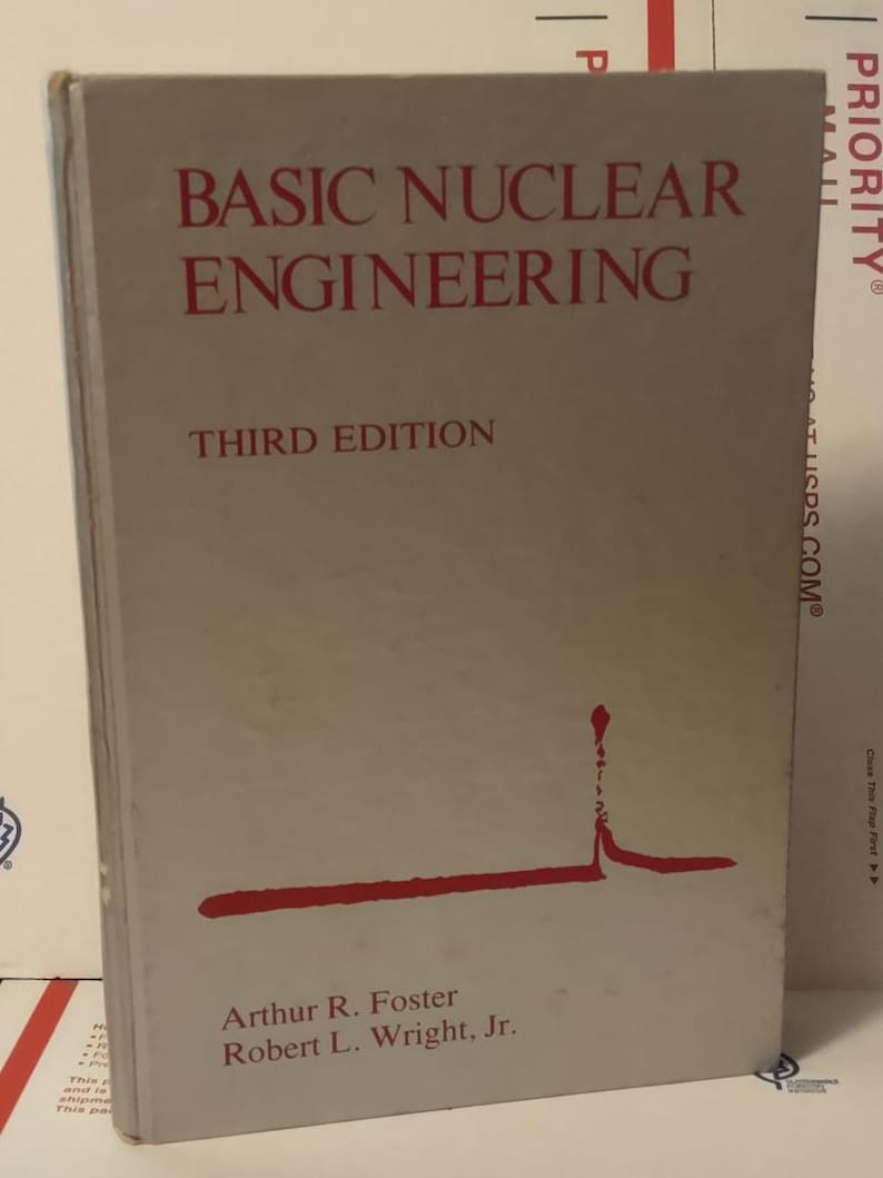 Puede incluir: Un libro de tapa dura titulado "BASIC NUCLEAR ENGINEERING" en letras rojas. El libro es una tercera edici&oacute;n, con los autores Arthur R. Foster y Robert L. Wright, Jr. La portada es de color beige claro con un gr&aacute;fico rojo.
