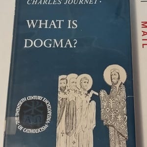 May include: A blue book cover with the title "What is Dogma?" by Charles Journet. The book is part of "The Twentieth Century Encyclopedia of Catholicism".