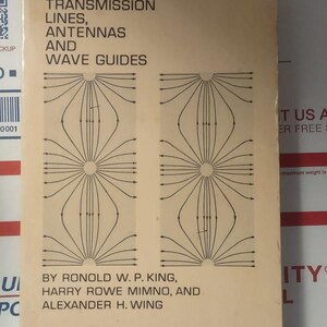 May include: A vintage book titled "TRANSMISSION LINES, ANTENNAS AND WAVE GUIDES" with a beige cover. The cover features a black graphic design of radiating lines. The authors' names are listed below the title.