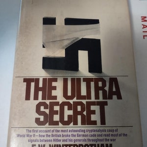 May include: A white book with a black and white image of a swastika on the cover. The title of the book is "The Ultra Secret" in large, bold, brown letters. The author's name, "F. W. Winterbotham", is printed in black below the title.