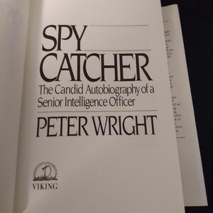 May include: A book cover with the title "SPY CATCHER" in large, bold, black letters. The subtitle is "The Candid Autobiography of a Senior Intelligence Officer" in smaller, black letters. The author's name, "PETER WRIGHT", is in large, bold, black letters below the subtitle. The cover also features a small Viking logo in the bottom left corner.