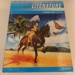 May include: A blue and white textbook with the title "Prentice Hall Literature Common Core Edition" and a picture of a person riding a horse on a beach with butterflies flying in the air.