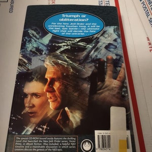 May include: A book cover with a dark blue background featuring a scene from the Star Wars universe. The cover text reads "Triumph or obliteration?" and "For the New Jedi Order and the unrelenting Yuuzhan Vong, it will be the last, epic battle - the ultimate fight that will decide the fate of the universe..."