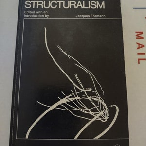 May include: A black and white book cover with the title "Structuralism" in white text. The book is edited with an introduction by Jacques Ehrmann. The cover also includes a white abstract design and the text "A Doubleday Anchor Original".