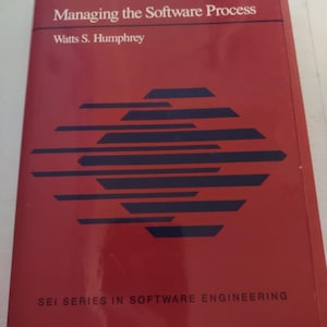 May include: A red book titled "Managing the Software Process" by Watts S. Humphrey. The book is part of the SEI Series in Software Engineering.