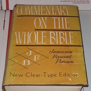 May include: A vintage book titled "Commentary on the Whole Bible" with a yellow cover and white lettering. The book's title is prominently displayed, along with the authors' names, "Jamieson Fausset Brown." The book is a "New Clear-Type Edition."