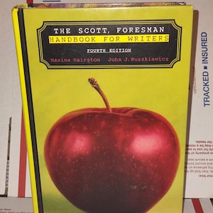 May include: A hardcover book titled "The Scott, Foresman Handbook for Writers" with a large red apple illustration on the cover. The book is yellow with black text and a black border. The fourth edition is also noted.
