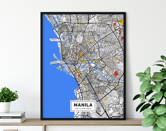 May include: Framed map print of Manila, Philippines. The map features a detailed street grid in black and white, with blue representing the sea. Yellow and red accents highlight specific areas. The city name is displayed in a white rectangle.
