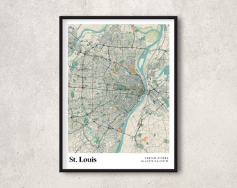 May include: Framed map print of St. Louis, Missouri, featuring a detailed street layout in shades of green, beige, and orange. The city's name is displayed in white text at the bottom left, with coordinates on the right.