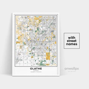 May include: A framed map print of Olathe, Kansas, showing street names. The map uses yellow, green, and grey tones to depict the city layout. The text "OLATHE" and coordinates are at the bottom. The words "with street names" are in a square.